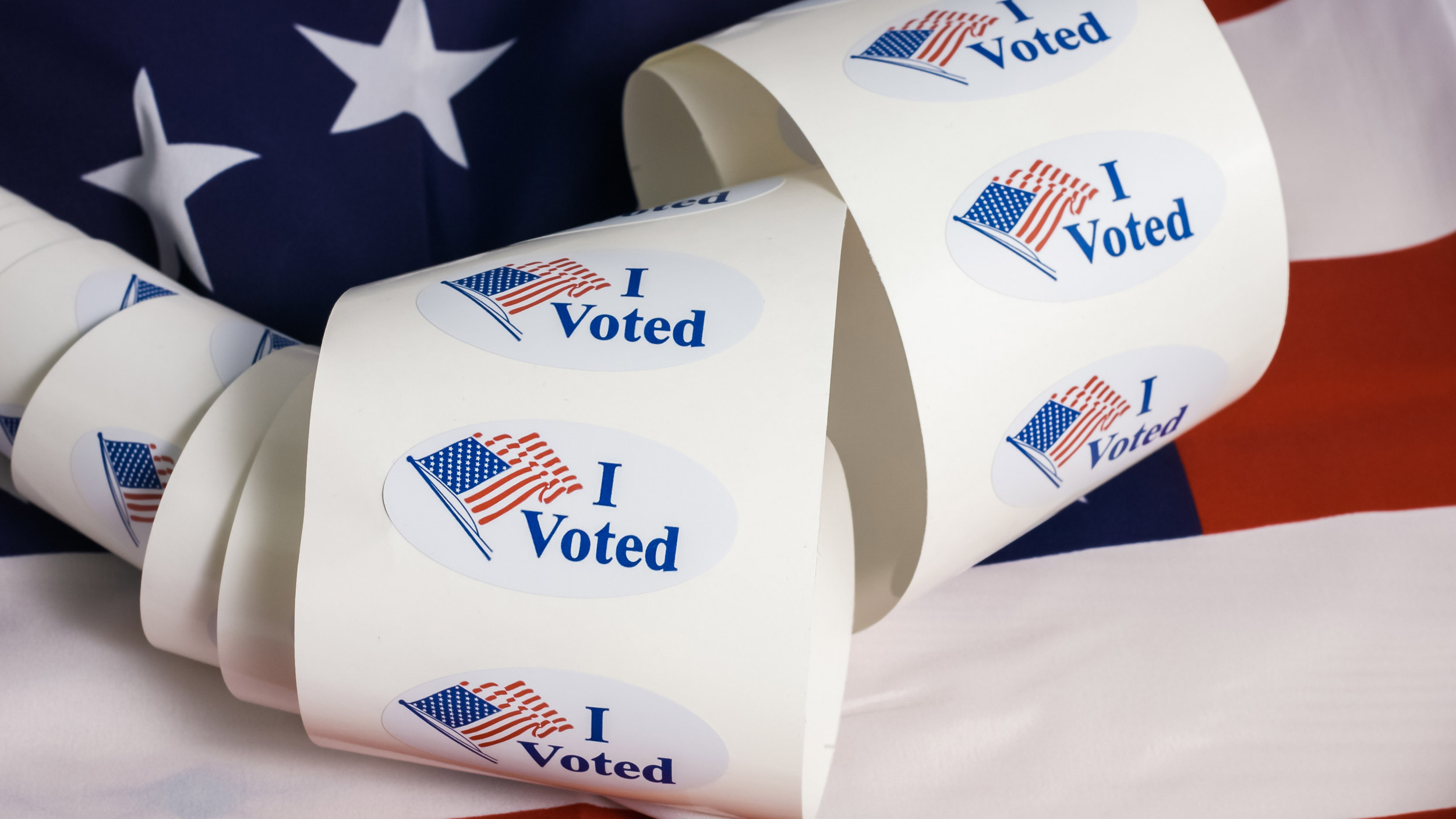 strip of I voted stickers with American flag