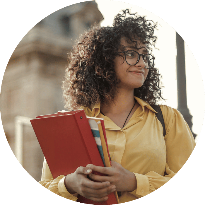 young female student holding books smiling